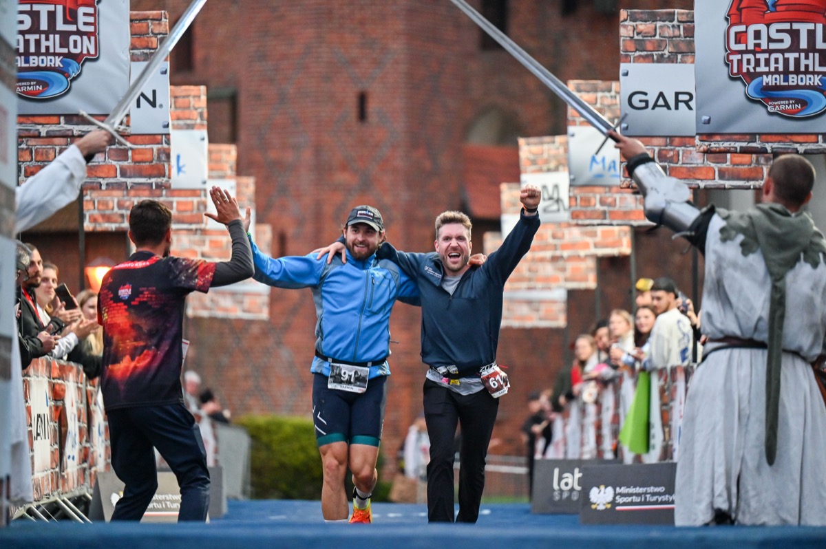 Chris and Dennis crossing the finish line together at Castle Triathlon Malbork